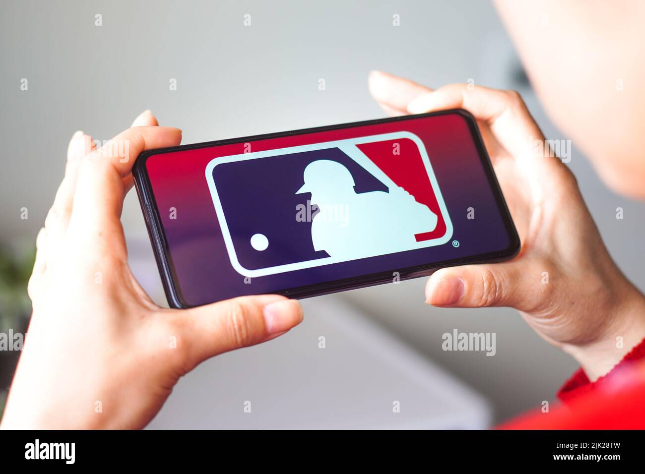 In this photo illustration, the Major League Baseball (MLB) logo is displayed on a smartphone screen. Stock Photo
