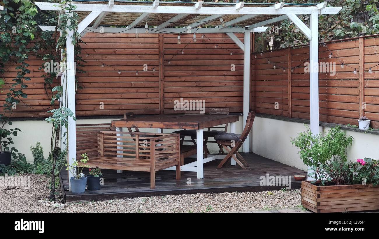 Gazebo with lights at night. Picture of a summer house with comfortable