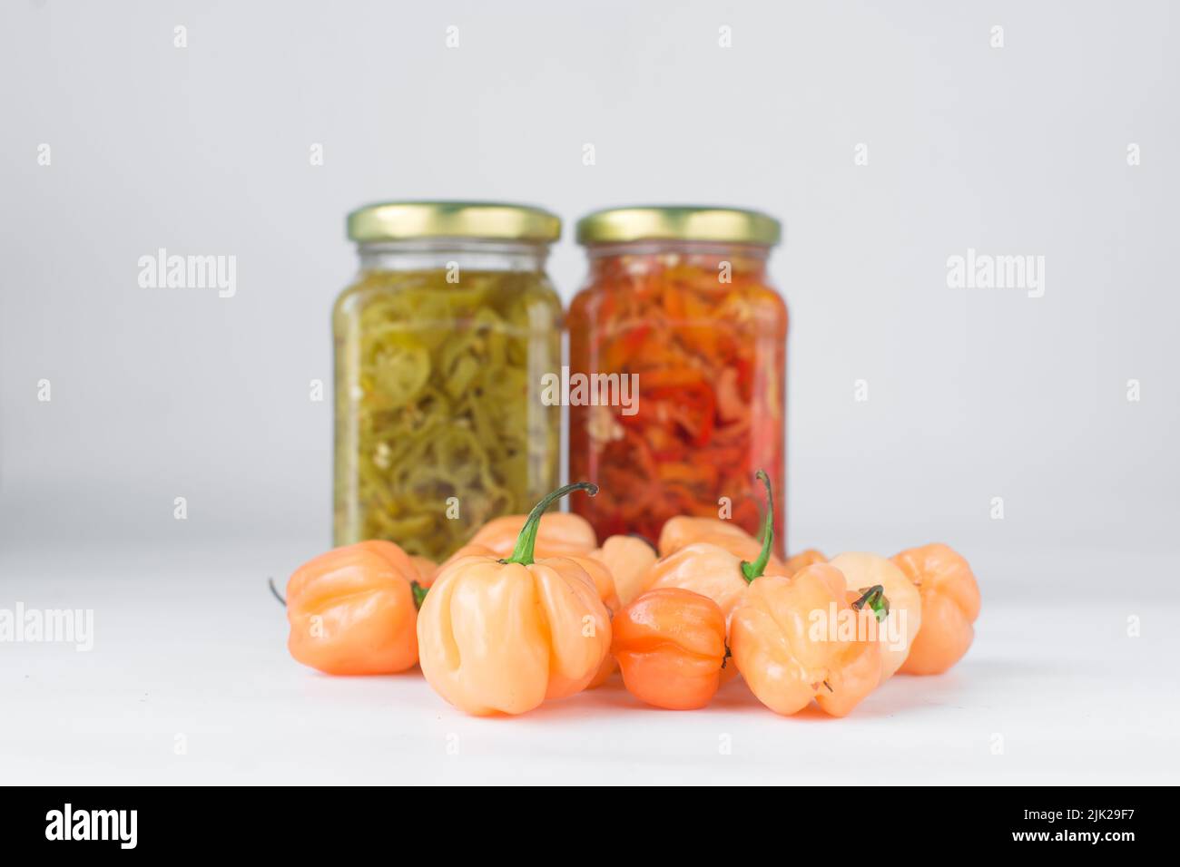 A scotch bonnet pepper with stem on a white background, fresh pepper, orange coral pepper, Nigerian scotch bonnet pepper Stock Photo