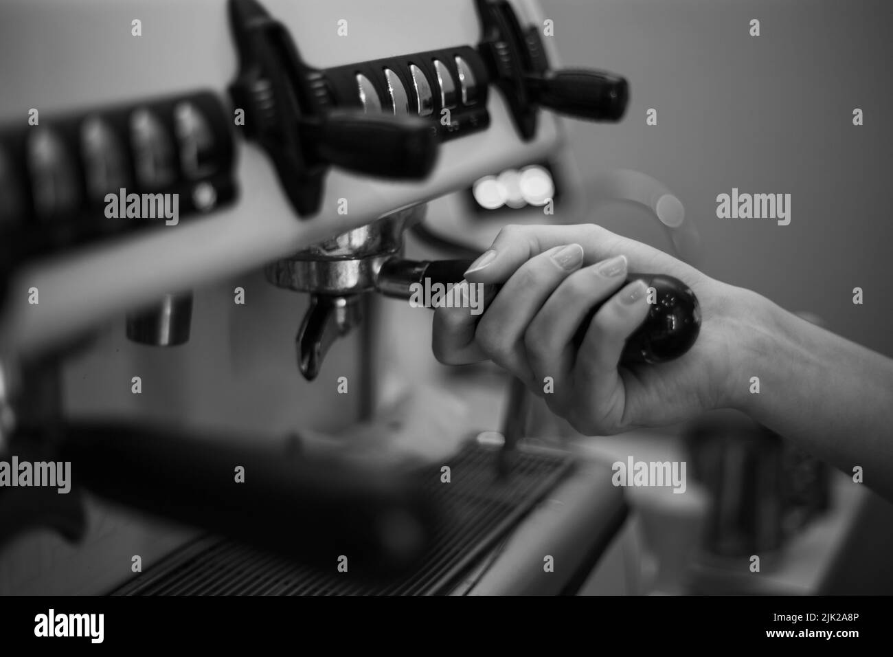 Barista holds a holder and makes coffee with a doubleboiler coffee