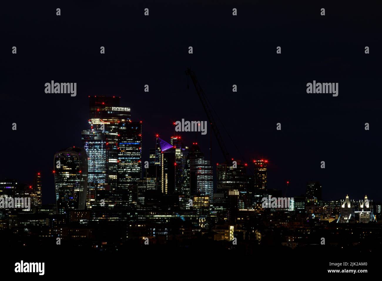 Scenic view of the City of London at night as seen from the South. The City is the primary central business district of London and the world Stock Photo
