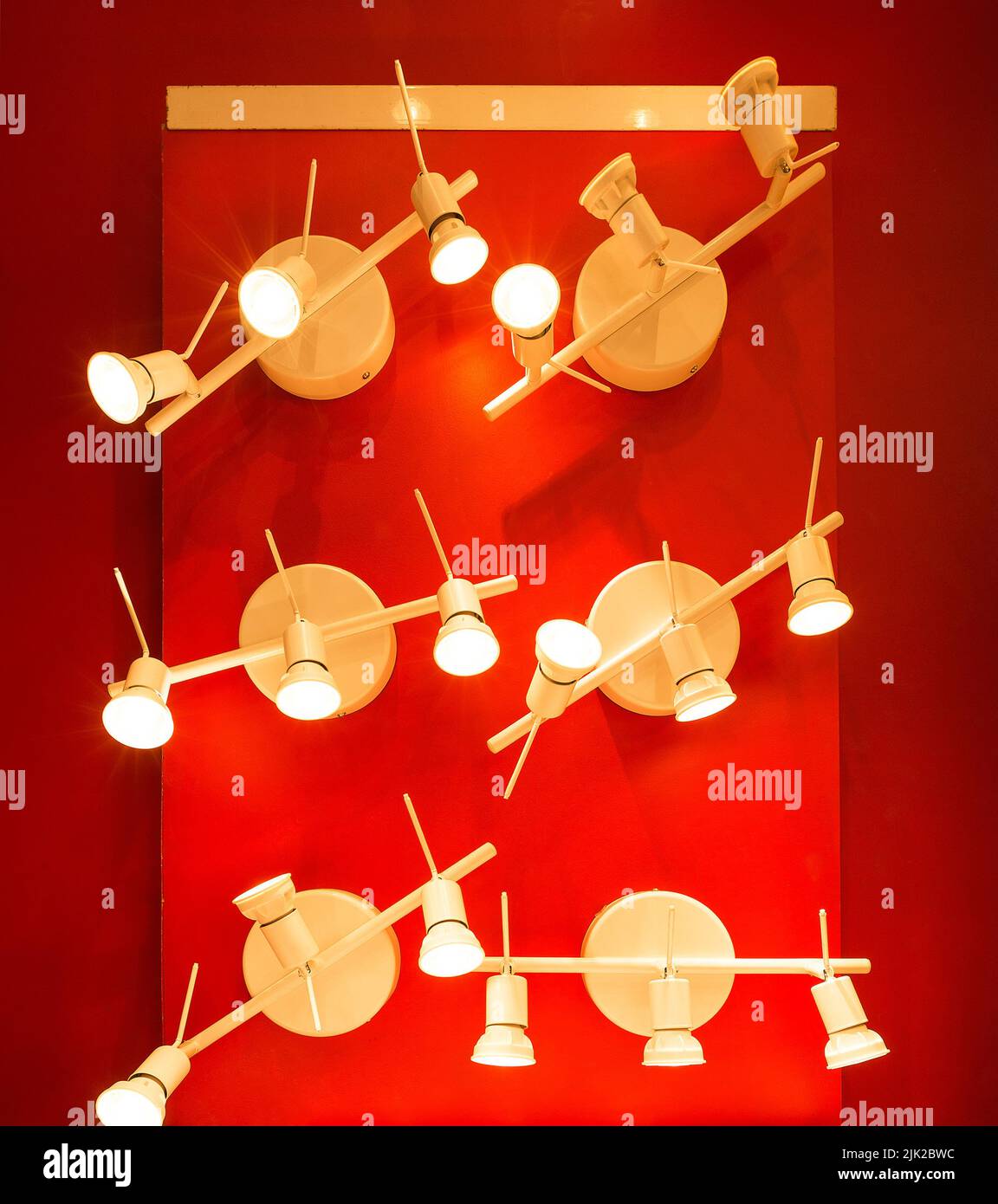 the on-wall red art object with halogen lamps Stock Photo