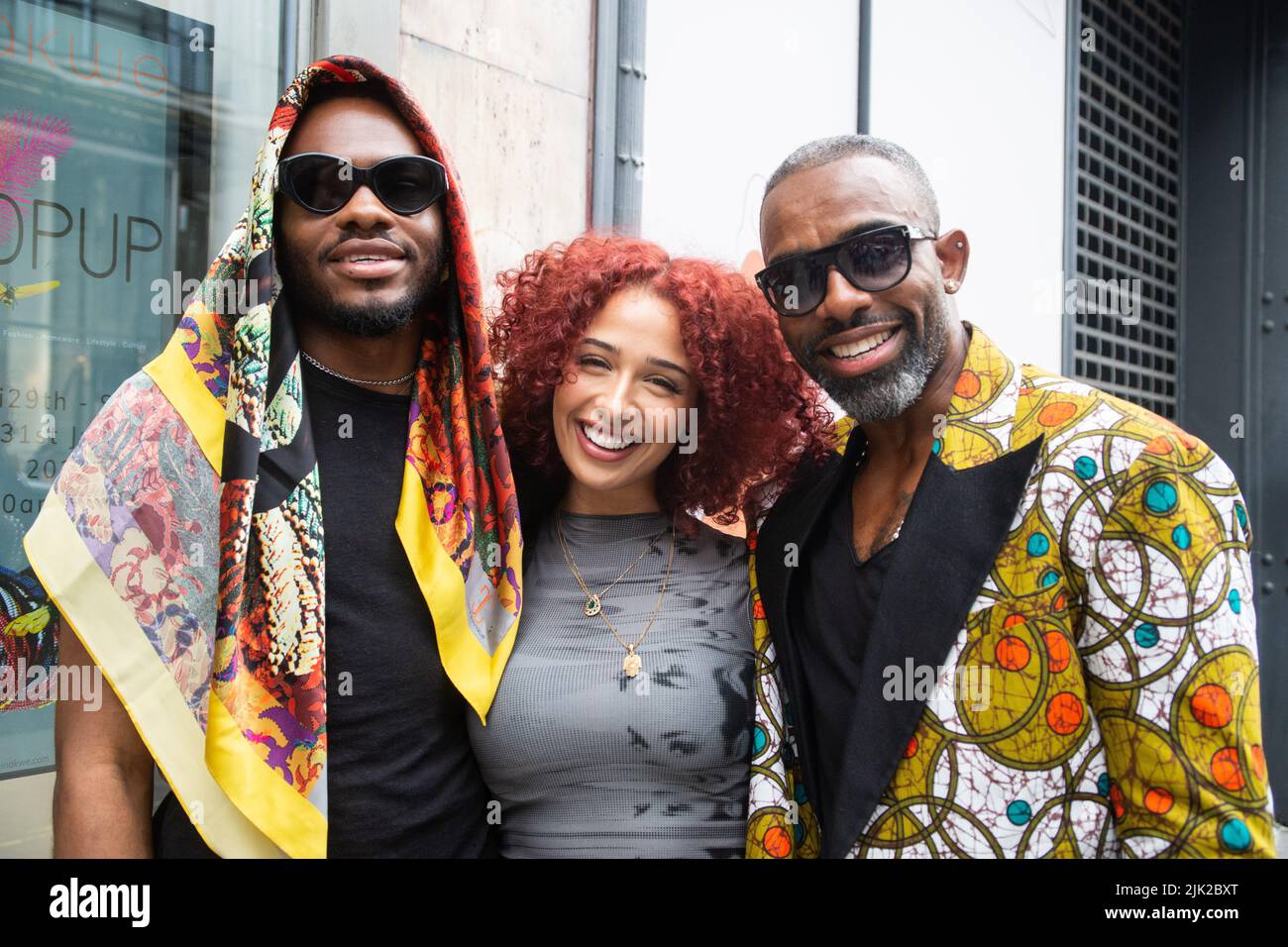 London, UK. 29th July, 2022. Marcel Venn, his partner, his father, actor Charles Venn. Caroline Chinakwe opens Pop Up Shop on Oxford Street, London. Nigerian born and UK based artist Caroline Chinakwe opened her pop up shop at SOOK, 58 Oxford Street, London, W1D 1BH, with a reception attended by luminaries of the art world and actor Charles Venn of Eastenders and Casualty fame and his son, Marcel. The pop up shop is open from the 29th July to the 31st from 10:00 am to 8:00pm. Credit: Peter Hogan/Alamy Live News Stock Photo