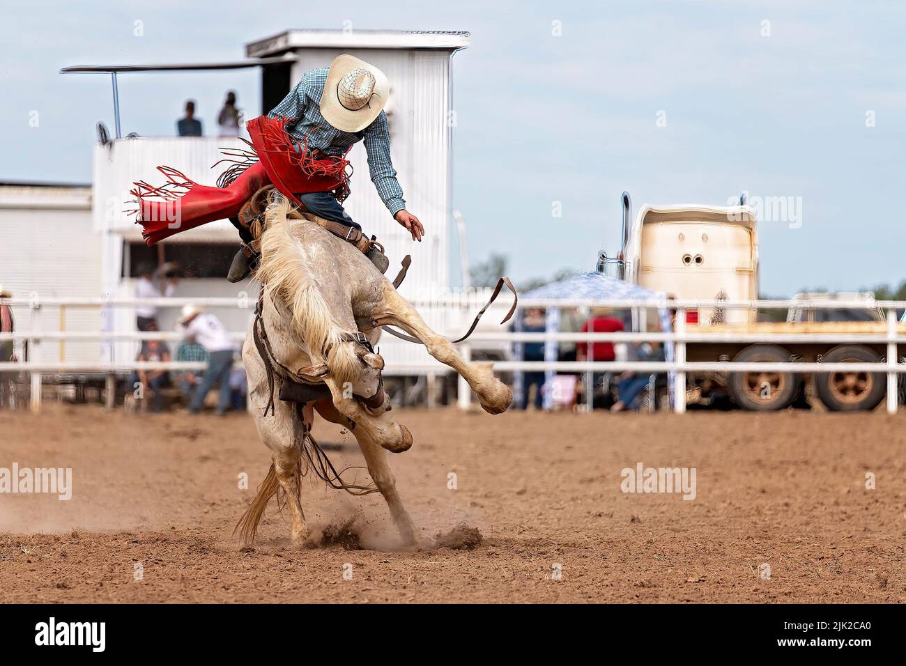 Cowboy riding a bucking bronc at a country rodeo Australia Stock Photo