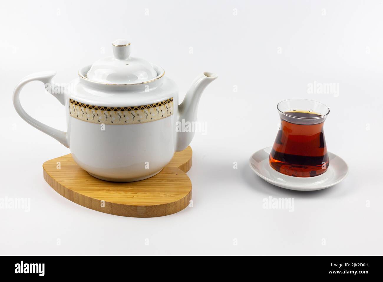 Tea in a porcelain teapot and Turkish style traditional tea glass.White