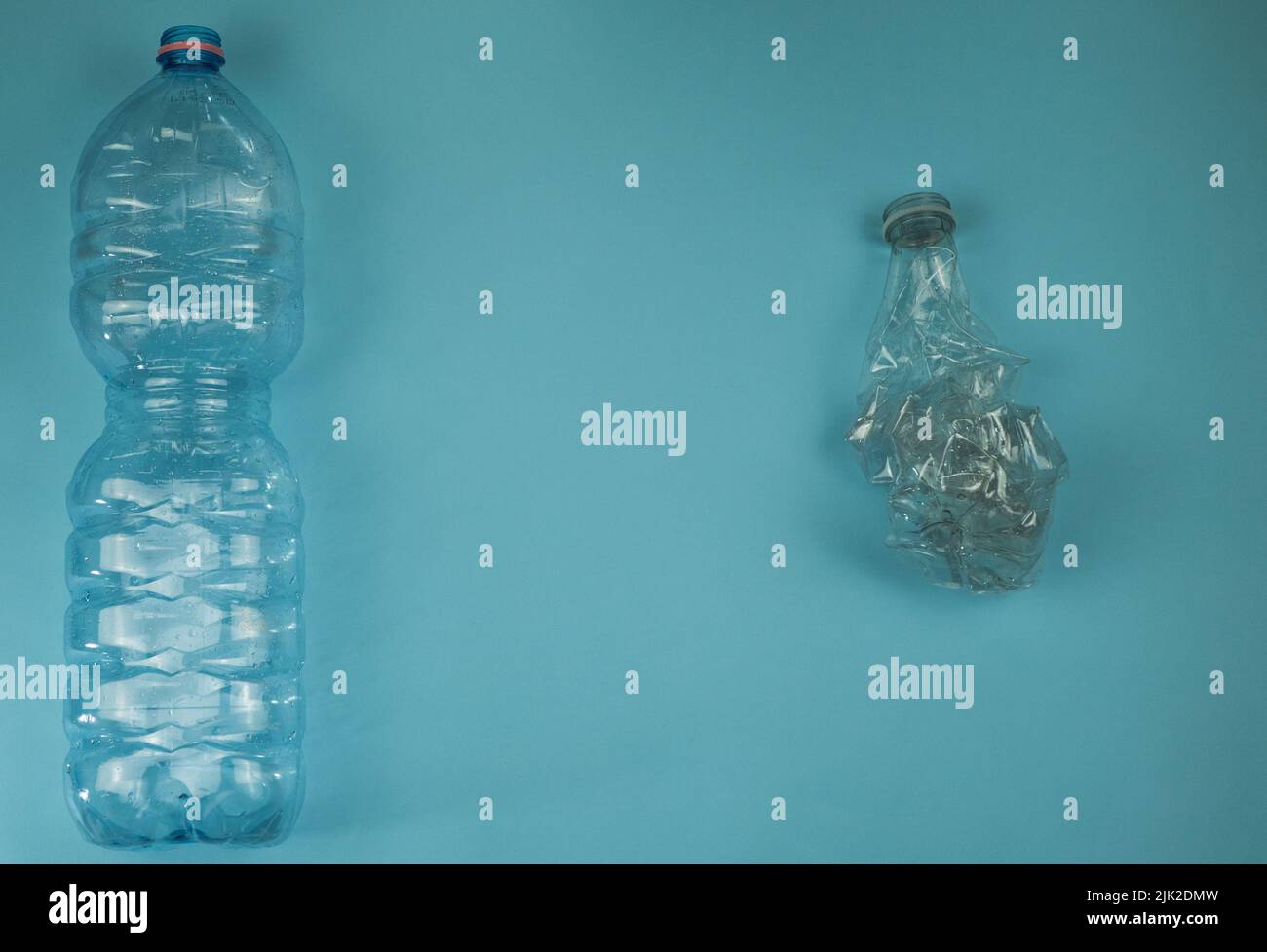 Used plastic bottles crushed and crumpled against on the blue