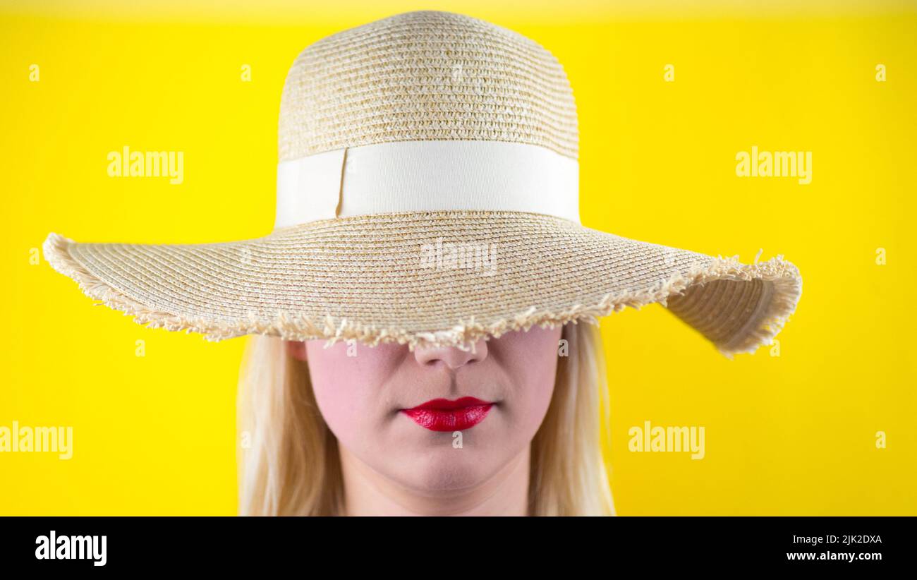 young girl in a retro hat. Isolated on yellow background Stock Photo ...