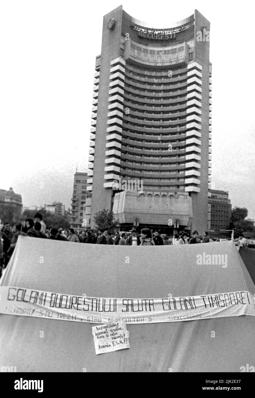 Bucharest, Romania, May 1990. 'Golaniada', a major anti-communism protest  in the University Square following the Romanian Revolution of 1989. People would gather daily to protest the ex-communists that took the power after the Revolution. The main demand was that no former party member would be allowed to run in the elections of May 20th. President Iliescu called the protesters 'golani' (hooligans). In this picture, a banner says 'The hooligans in Bucharest greet the hooligans in Timisoara'. Stock Photo