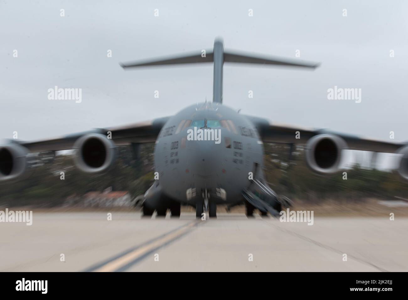 A U.S. Air Force C-17 Globemaster III aircraft with 21st Airlift Squadron, 60th Air Mobility Wing, Travis Air Force Base, California sits on a flight line during a joint training exercise at Marine Corps Air Station Camp Pendleton, California, July 25, 2022. This exercise included aircraft from five different Air Force squadrons and U.S. Marines with 3rd Battalion, 5th Marine Regiment, 1st Marine Division to enhance their expeditionary operations in a joint-training environment. This was the first time MCAS Camp Pendleton staged five C-17 Globemaster III aircraft on the air station at one time Stock Photo