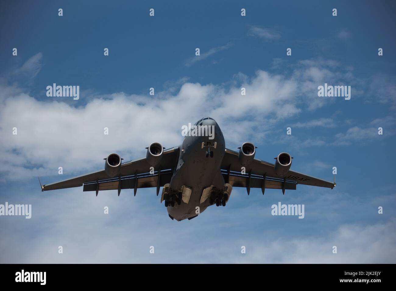 A U.S. Air Force C-17 Globemaster III aircraft prepares to land during a joint training exercise on Marine Corps Air Station Camp Pendleton, California, July 25, 2022. This exercise included aircraft from five different Air Force squadrons and U.S. Marines with 3rd Battalion, 5th Marine Regiment, 1st Marine Division to enhance their expeditionary operations in a joint-training environment. This was the first time MCAS Camp Pendleton staged five Globemaster III aircraft on the air station at the same time. (U.S. Marine Corps photo by Cpl. Shaina Jupiter) Stock Photo