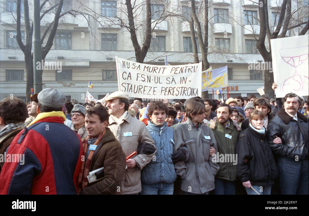 Bucharest, Romania, January 28, 1990. A month after the anti-communist revolution, supporters of the historical (right-wing) parties march against the new political party in power, F.S.N.,  composed mainly of former communist officials. A banner saying 'People did not die so that F.S.N. could reinstate Perestroika'. Stock Photo