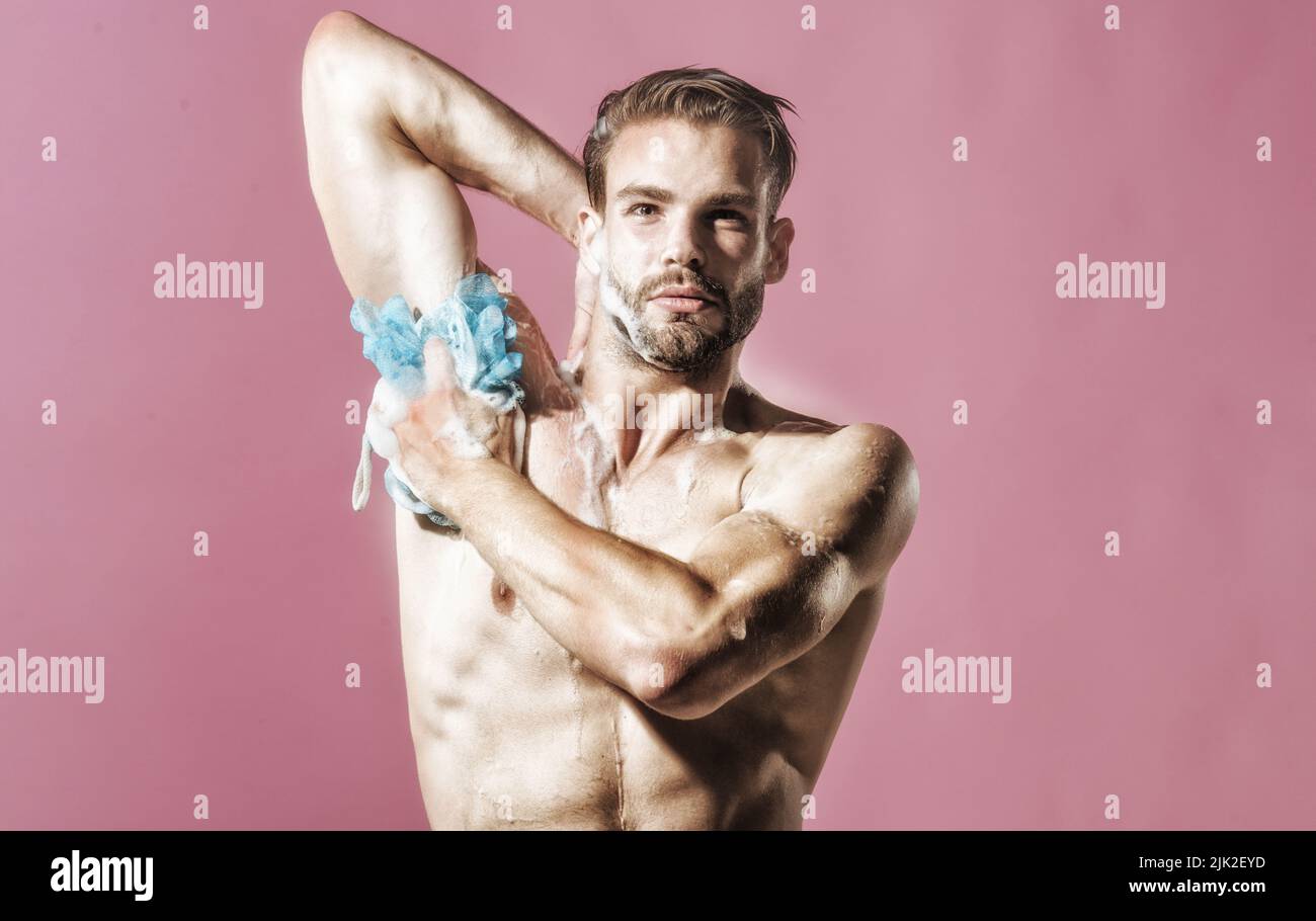 Handsome sexy guy taking shower. Muscular strong attractive unshaven hipster in bathroom. Naked man. Stock Photo