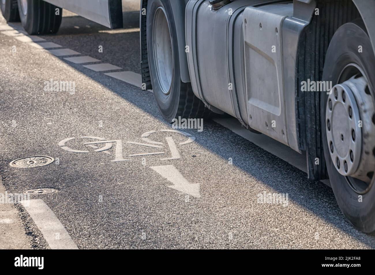 truck crossing the boundary line of a bike lane Stock Photo