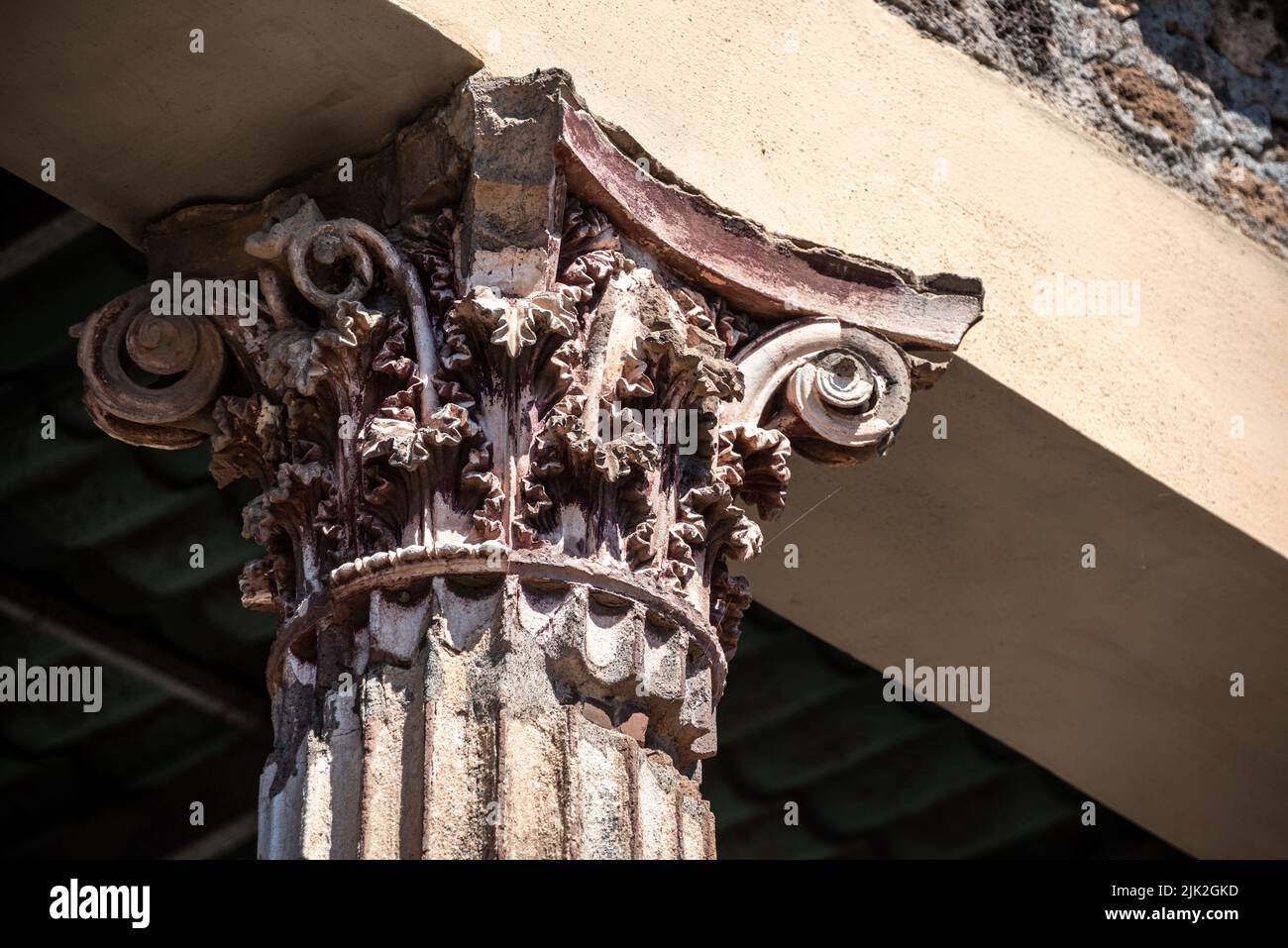Closeup of the capital of a corinthian column, once completely colored