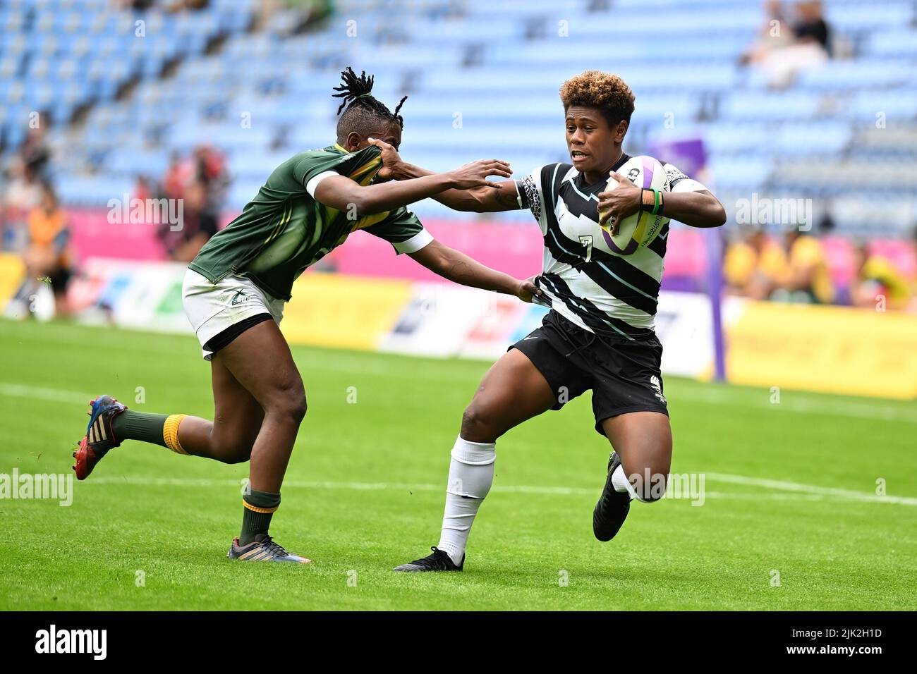 Lavena Cavuru of Fiji is tackled during the Rugby Sevens at the Commonwealth Games at Coventry