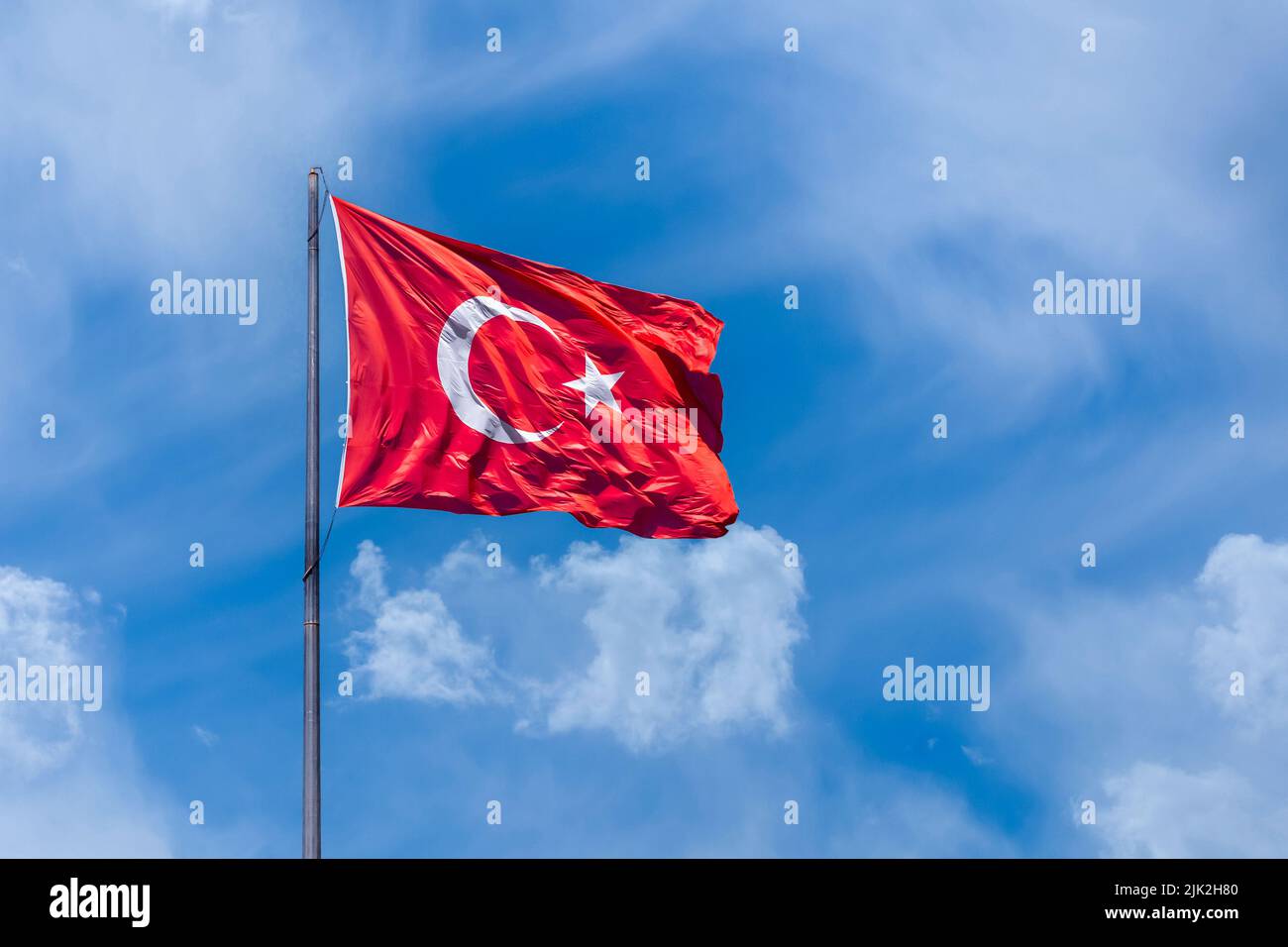 The Turkish flag is the national and official flag of the Republic of Turkey. It consists of a white crescent moon and star on a red background. It wa Stock Photo