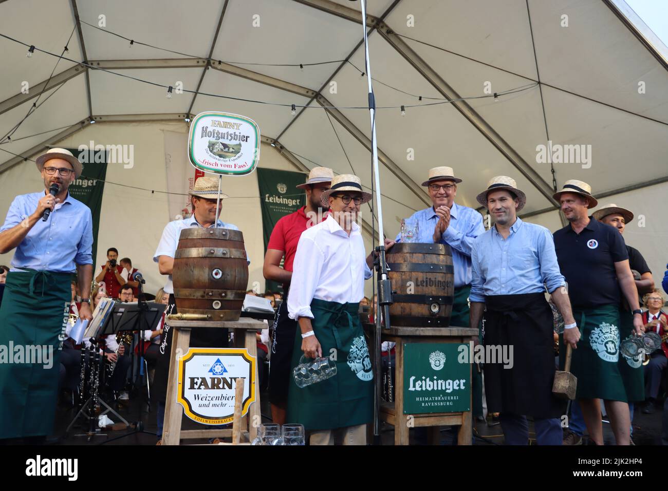 Langenargen, Germany. 29th July, 2022. The 47th Lakeside Festival at lake of constance („Bodensee“) was opened by ceremonical act with representatives of politics and municipality. With the traditional tapping of the barrel, a bavarian tradition that started 1850 at Munic-Wiesn (Oktoberfest). 3 days program started with orchestra and activities such as parachuting by the Bundeswehr, fireworks and a family fair for children. Montfort Castle, built in Moorish style in 1866, is Langenargen's magnificent landmark. Credit: RW Adventure Photography/Alamy Live News Stock Photo