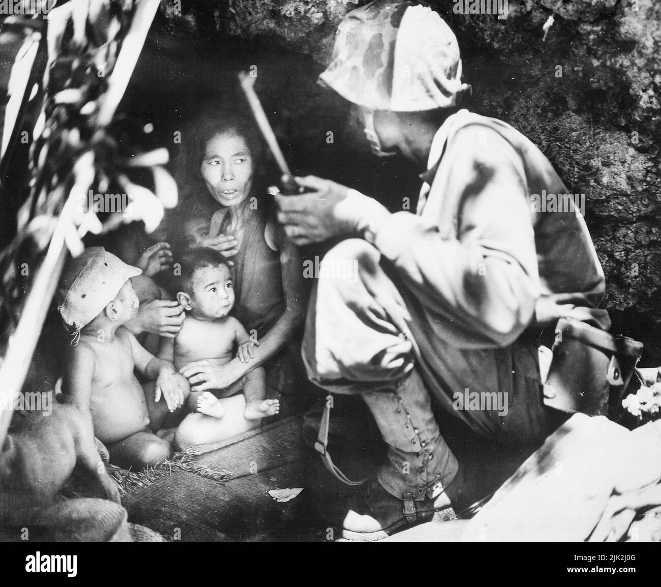 A member of a Marine patrol on Saipan found this family of Japs hiding in a hillside cave. The mother, four children and a dog, took shelter from the fierce fighting in that area. Stock Photo