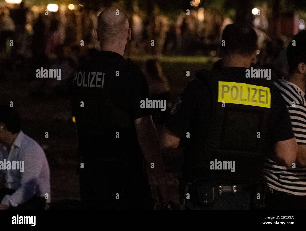 Berlin, Germany. 29th July, 2022. Employees of the Ordnungsamt Bezirk Mitte walk through James Simon Park with police officers. After riots, there is an alcohol ban there as well as in Monbijoupark from 10 p.m. to 6 a.m. Credit: Paul Zinken/dpa/Alamy Live News Stock Photo