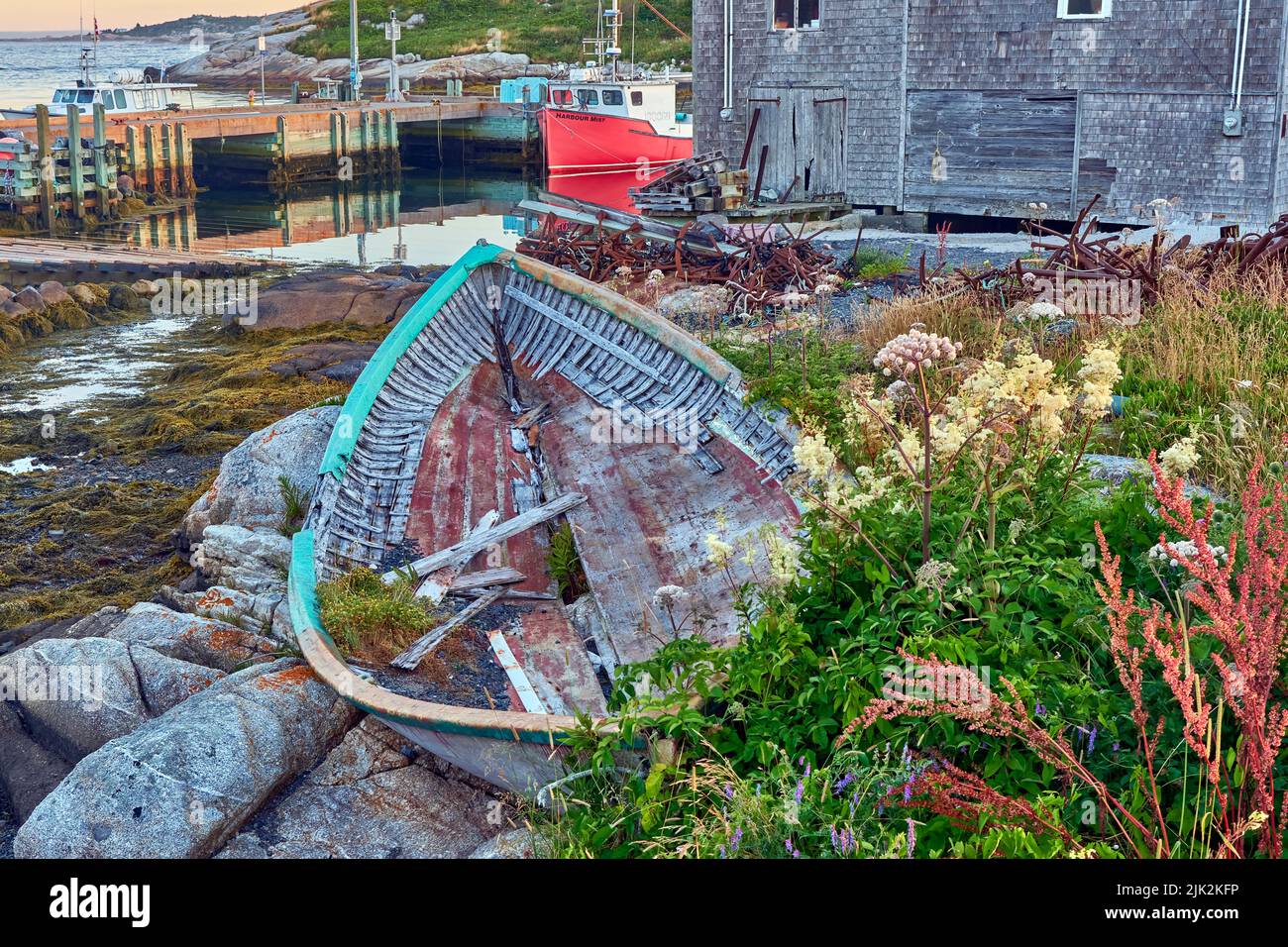 Derelict dorey discarded on the rocks at the edge of the harbour in Pegg's Cove Nova Scotia. Stock Photo