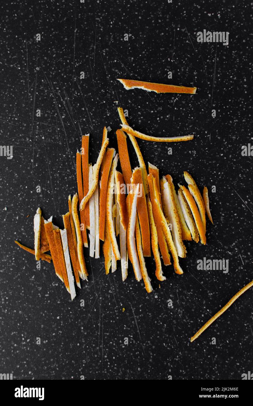 Orange rind thinly sliced, julienned orange rind on cutting board