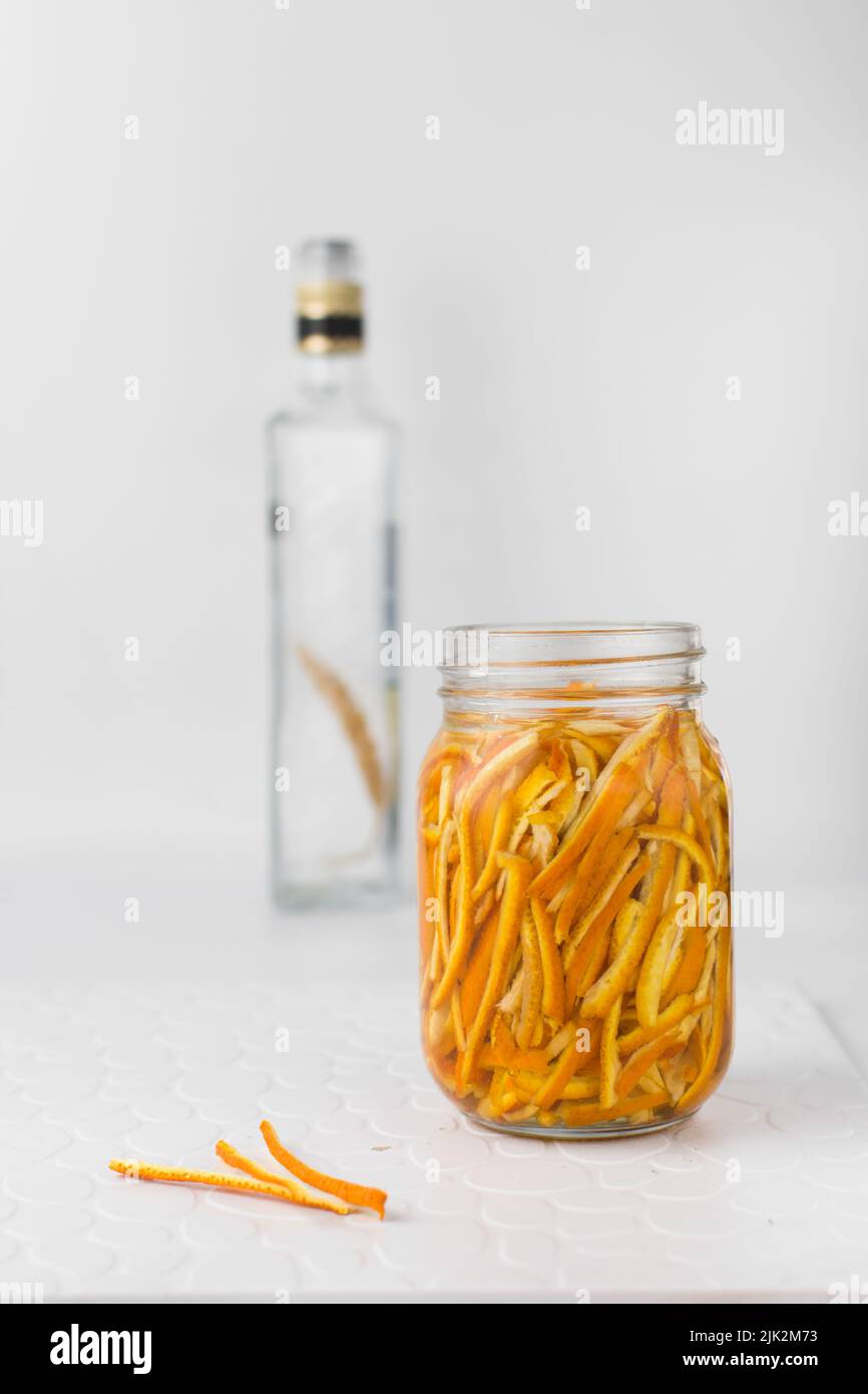 Making orange extract, orange peel in a glass jar, sliced orange rind Stock Photo