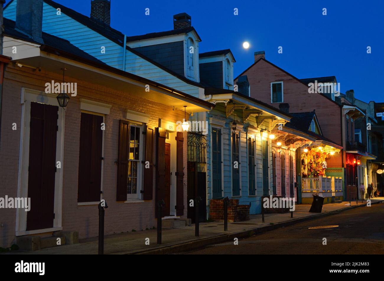 A full moon rises over the homes in the French Quarter of New Orleans Louisiana Stock Photo