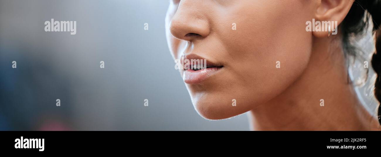 Closeup banner of a womans face, mouth and chin with blurred copy space. Young female looking confident, focused and determined. Breathing deeply Stock Photo