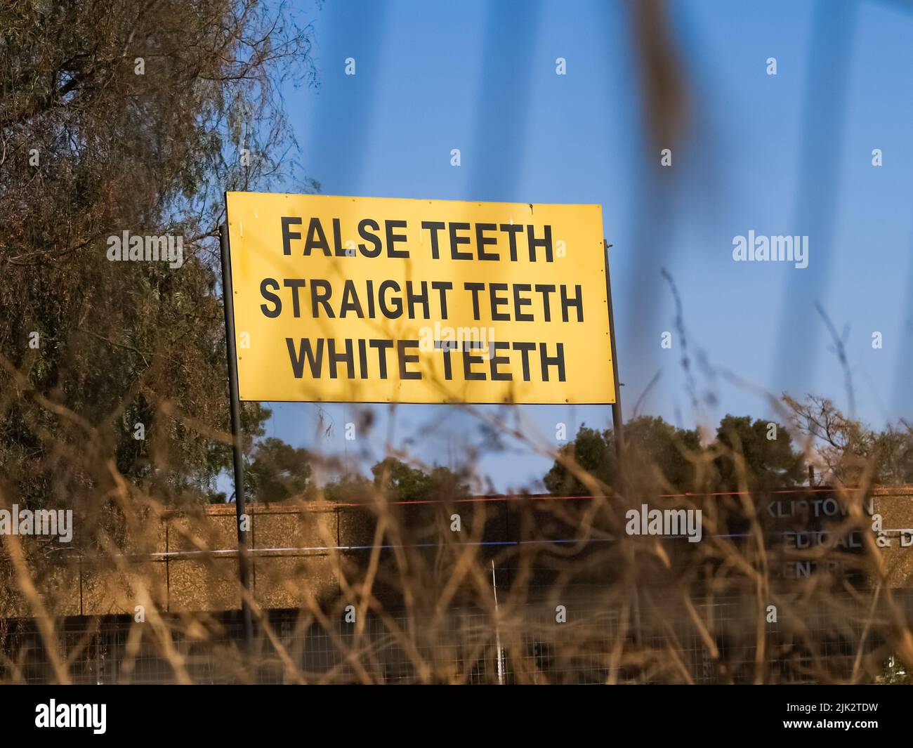 Johannesburg South Africa August 15 2007; Simple yellow sign with black text promoting dental