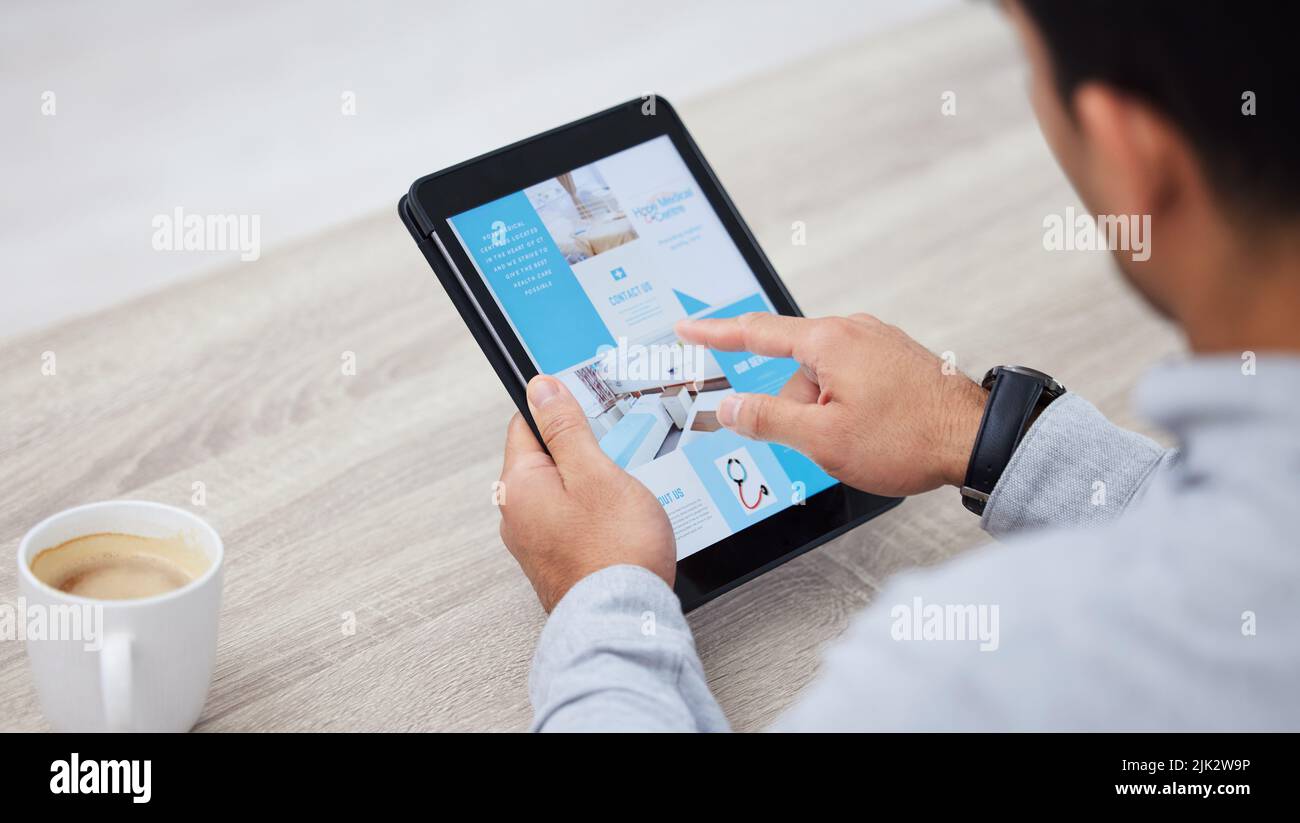 Time to start redecorating. a businessman drinking coffee while using his digital tablet. Stock Photo