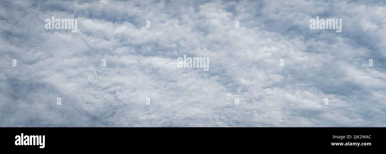 Fleecy clouds texture, cloudy sky background, wide banner size gray cloudscape Stock Photo