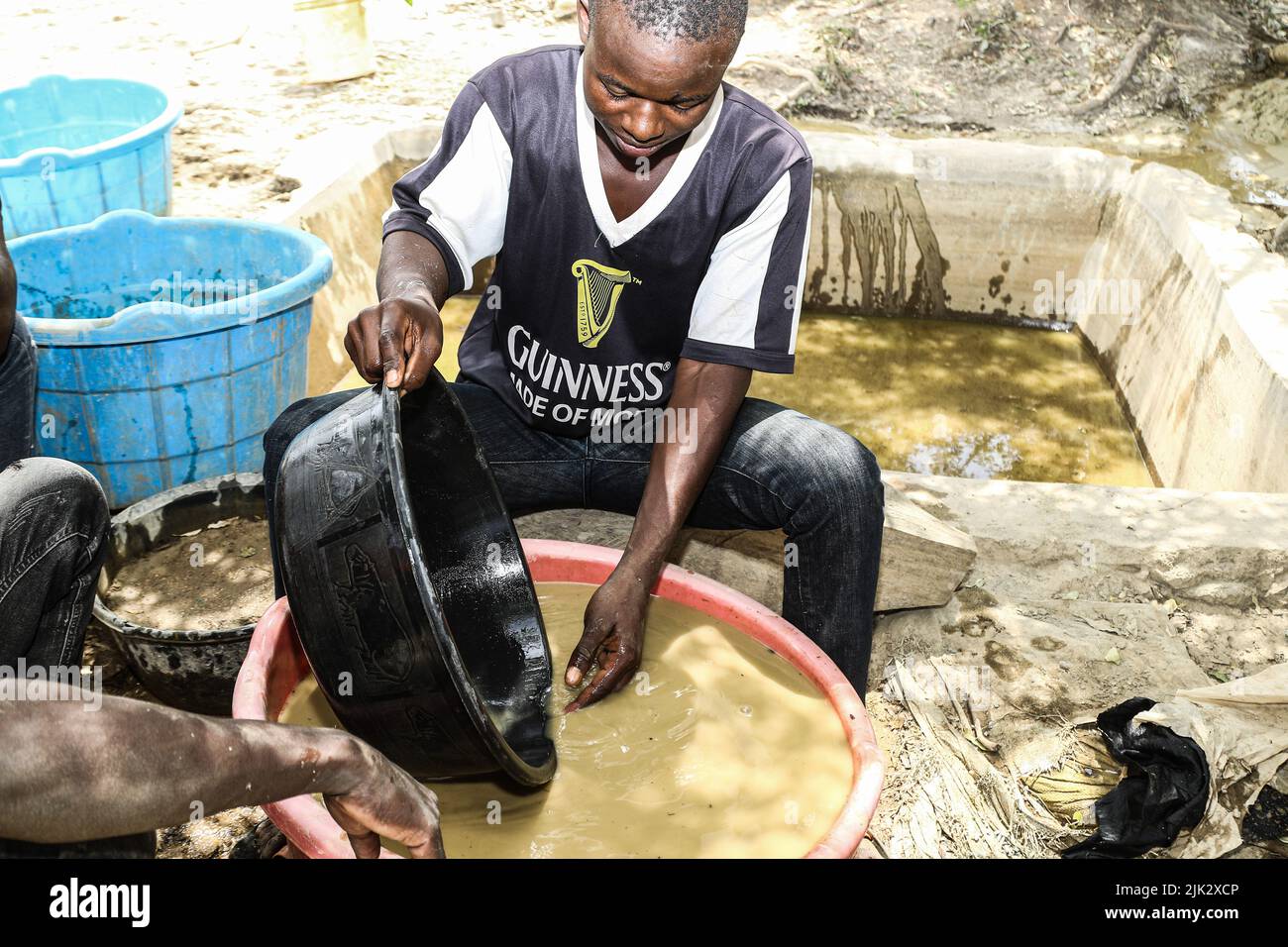 A miner is seen panning for gold at a mining site in Mikei. Artisanal
