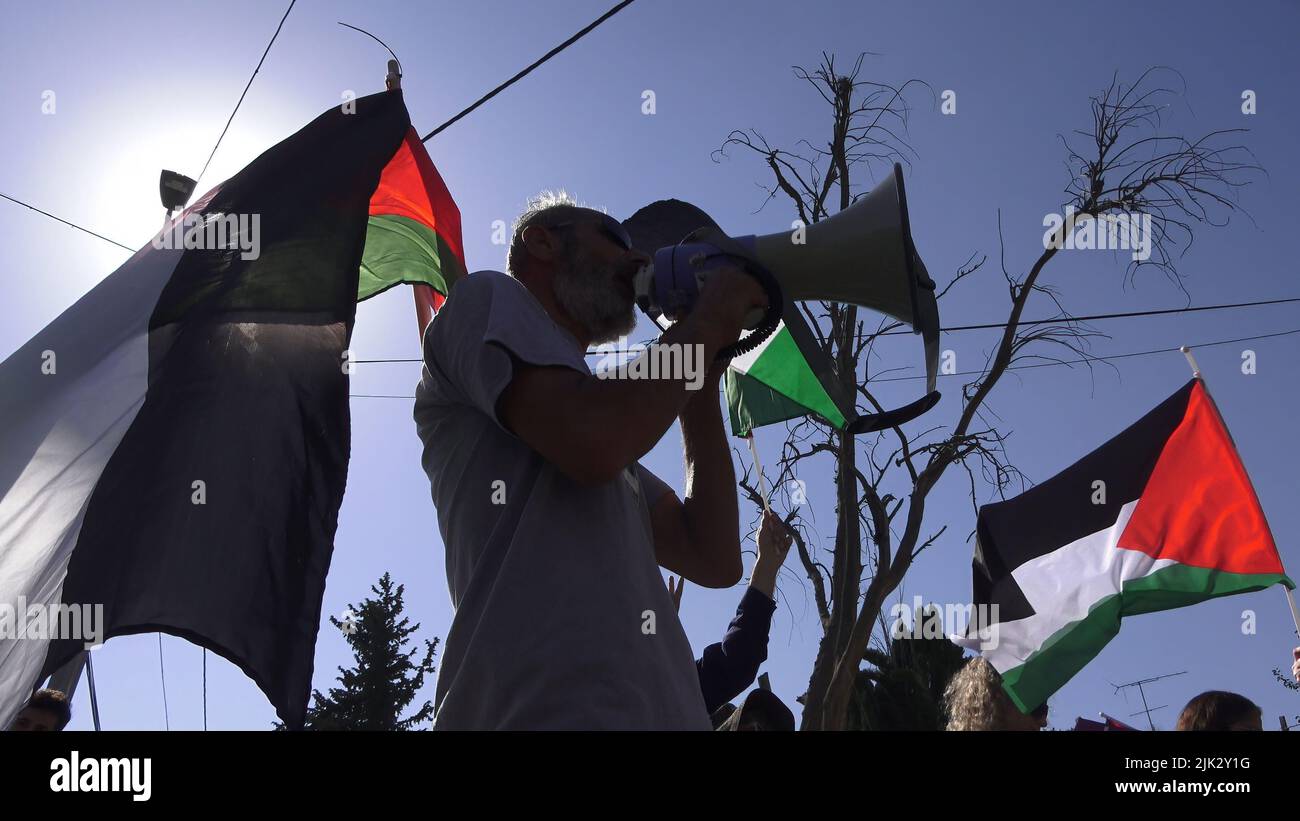 Jerusalem, Israel. 29th July, 2022. JERUSALEM, ISRAEL - JULY 29: Israeli left-wing activists and Palestinians hold Palestinian flags and shout slogans during a demonstration against Israeli occupation and settlement activity in the Sheikh Jarrah neighborhood on July 29, 2022 in Jerusalem, Israel. The Palestinian neighborhood of Sheikh Jarrah is currently the center of a number of property disputes between Palestinians and right-wing Jewish Israelis. Some houses were occupied by Israeli settlers following a court ruling.  Credit: Eddie Gerald/Alamy Live News Credit: Eddie Gerald/Alamy Live News Stock Photo