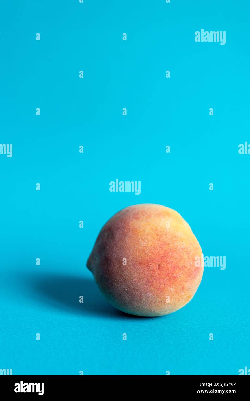 Peach on a blue background Stock Photo