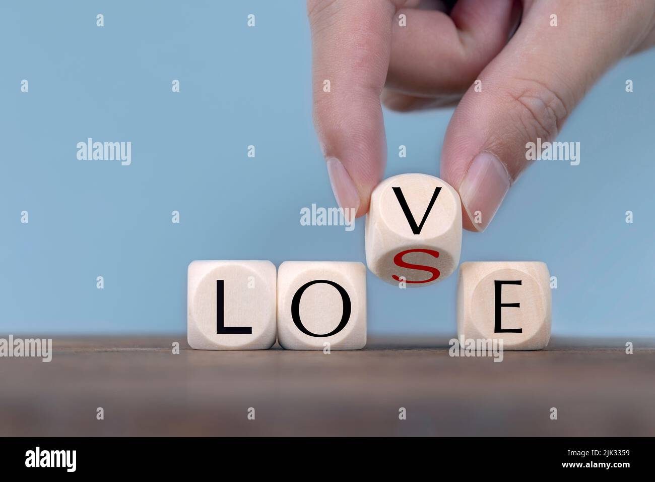 Hand Changing word from love to lose On Wooden Cube Stock Photo