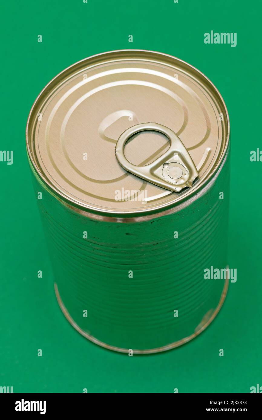 Unopened Tin Can with Blank Edge on Green Background. Canned Food
