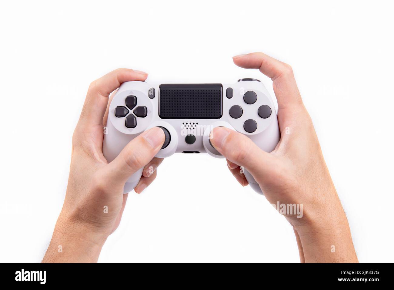 Joystick gaming controller in hand isolated on white background , Video game console developed Interactive Entertainment Stock Photo