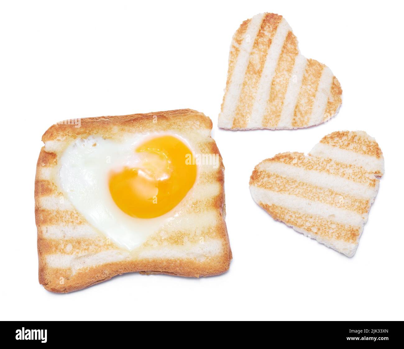Heart shaped fried eggs in a Toasted bread with grill marks isolated on