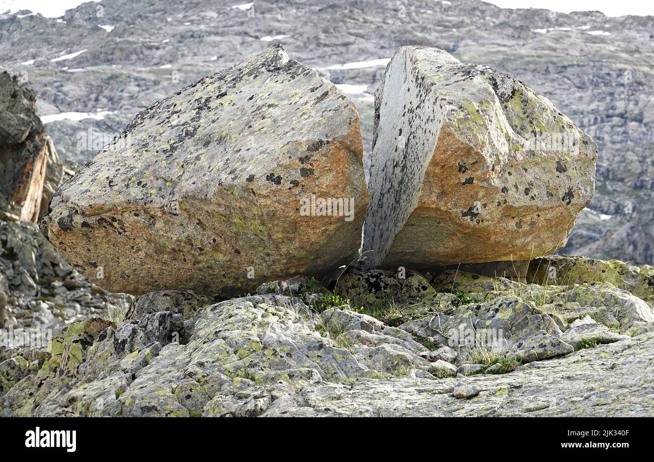 Glacial erratic, split stone on rock, remnant of a disappeared glacier Stock Photo