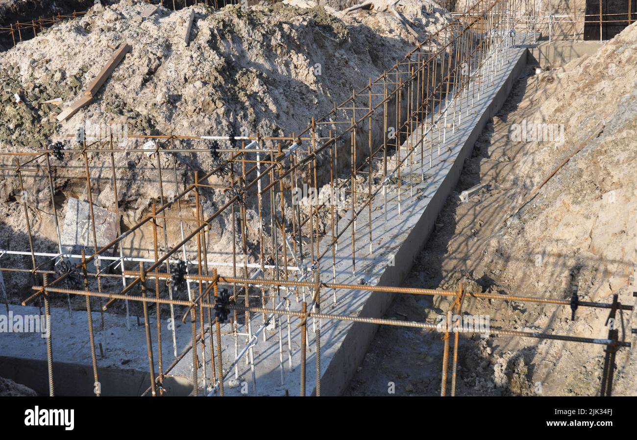 A closeup of a concrete footing, concrete house foundation