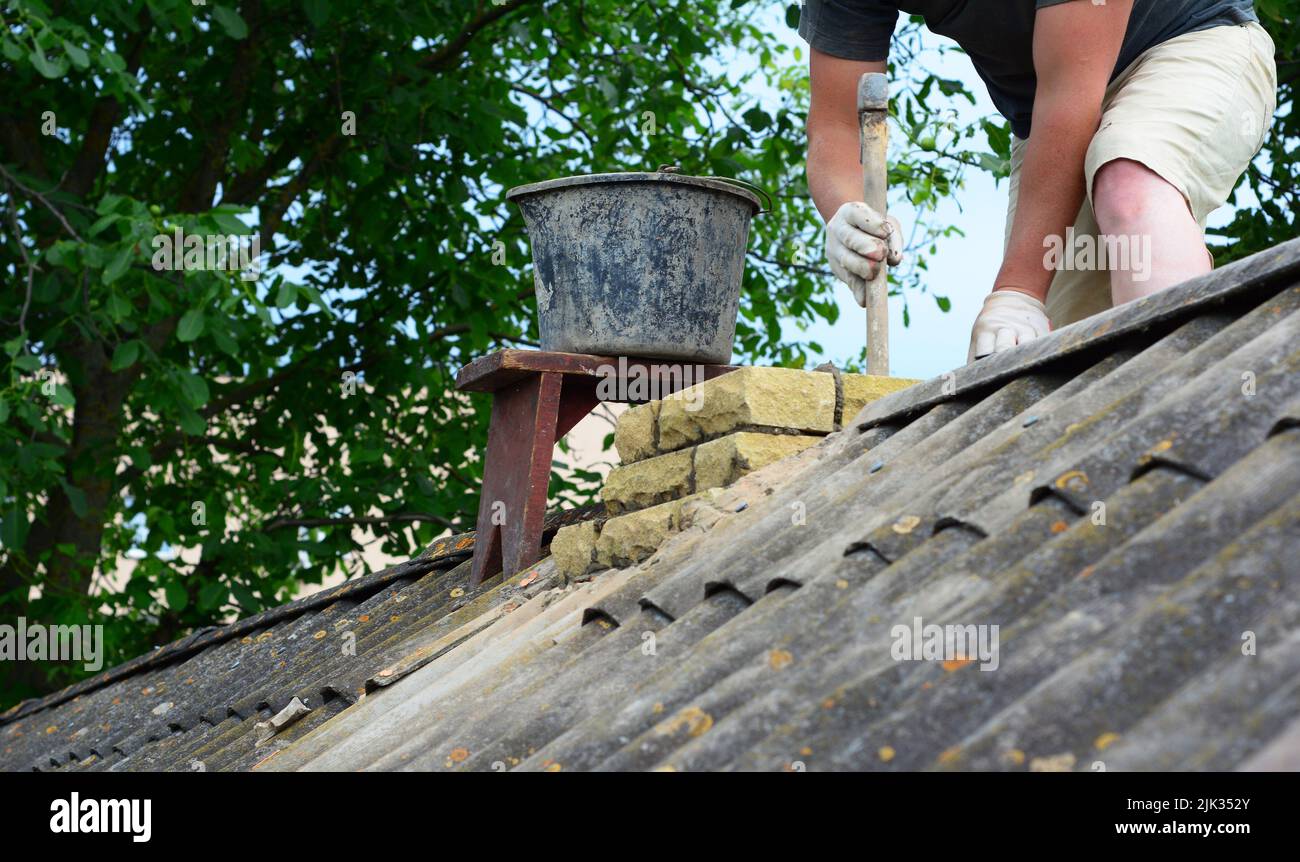 Masonry chimney construction. A contractor is building, repairing a ...