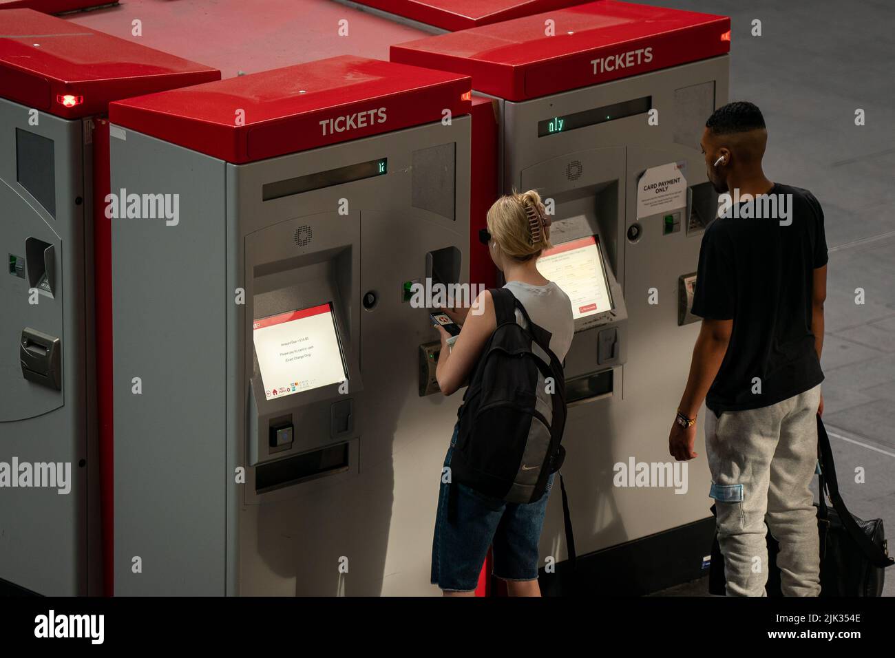 People use the ticket machines in Kings Cross train station as members of the Rail, Maritime and Transport union (RMT) take part in a fresh strike over jobs, pay and conditions. Picture date: Wednesday July 27, 2022. Stock Photo