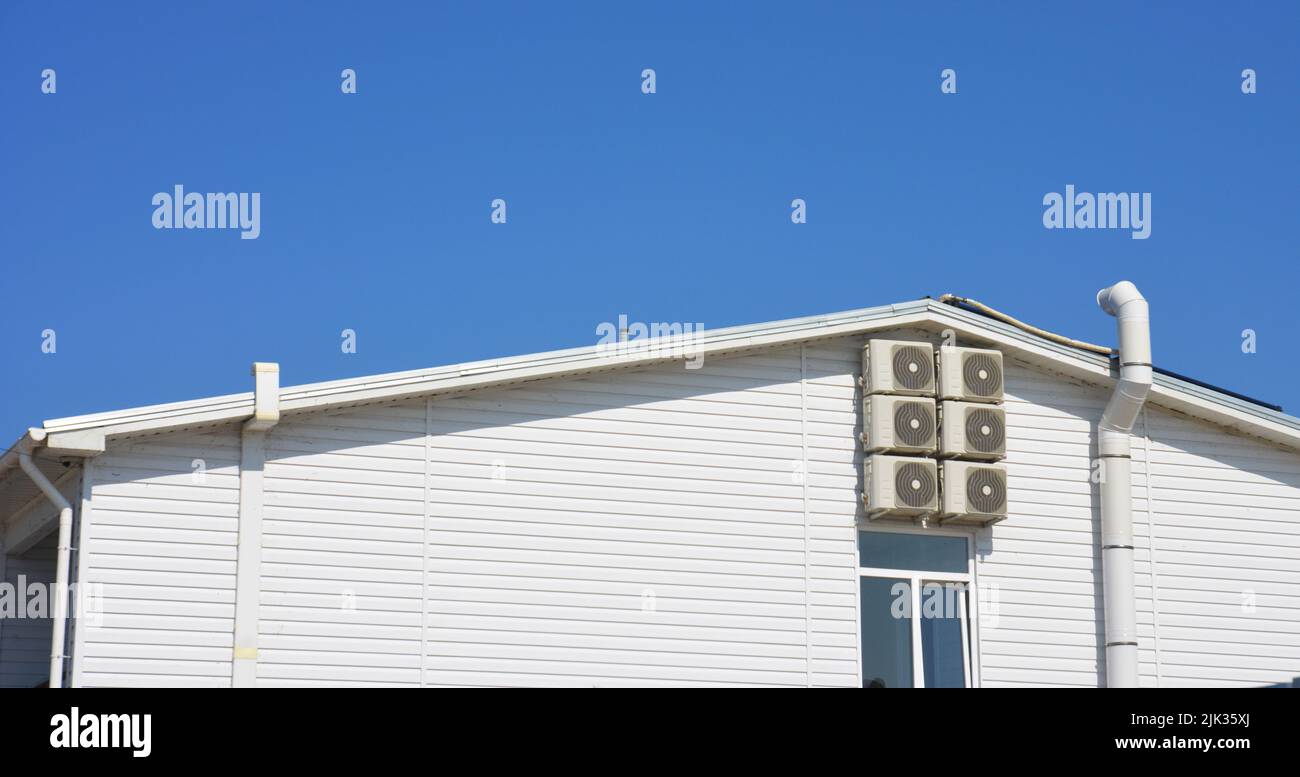 An outdoor view on a HVAC system of a house with ventilation air ducts