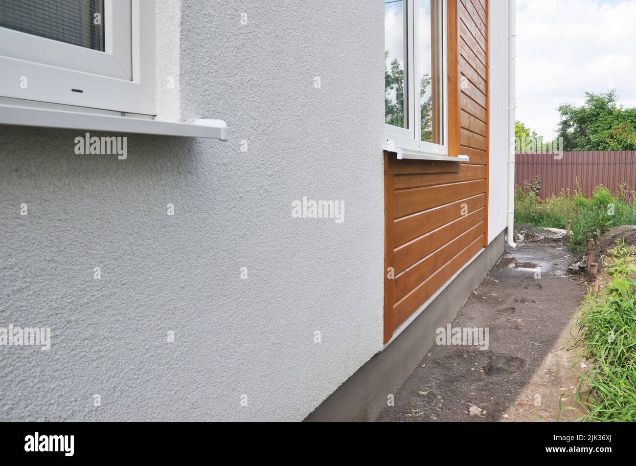 Modern house facade insulation under plastering, stucco and wood wall