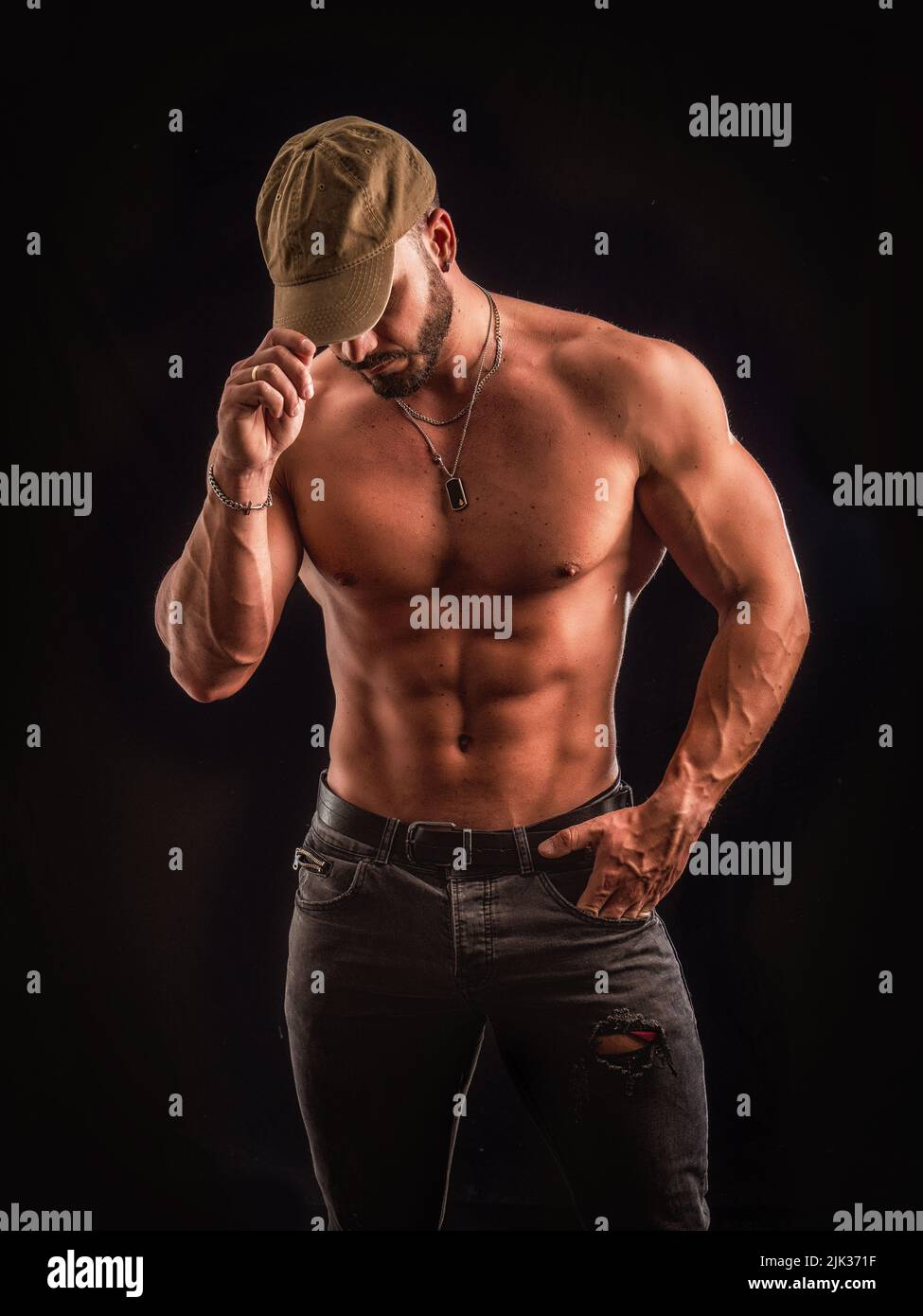 Shirtless muscular male bodybuilder in studio shot on black Stock Photo