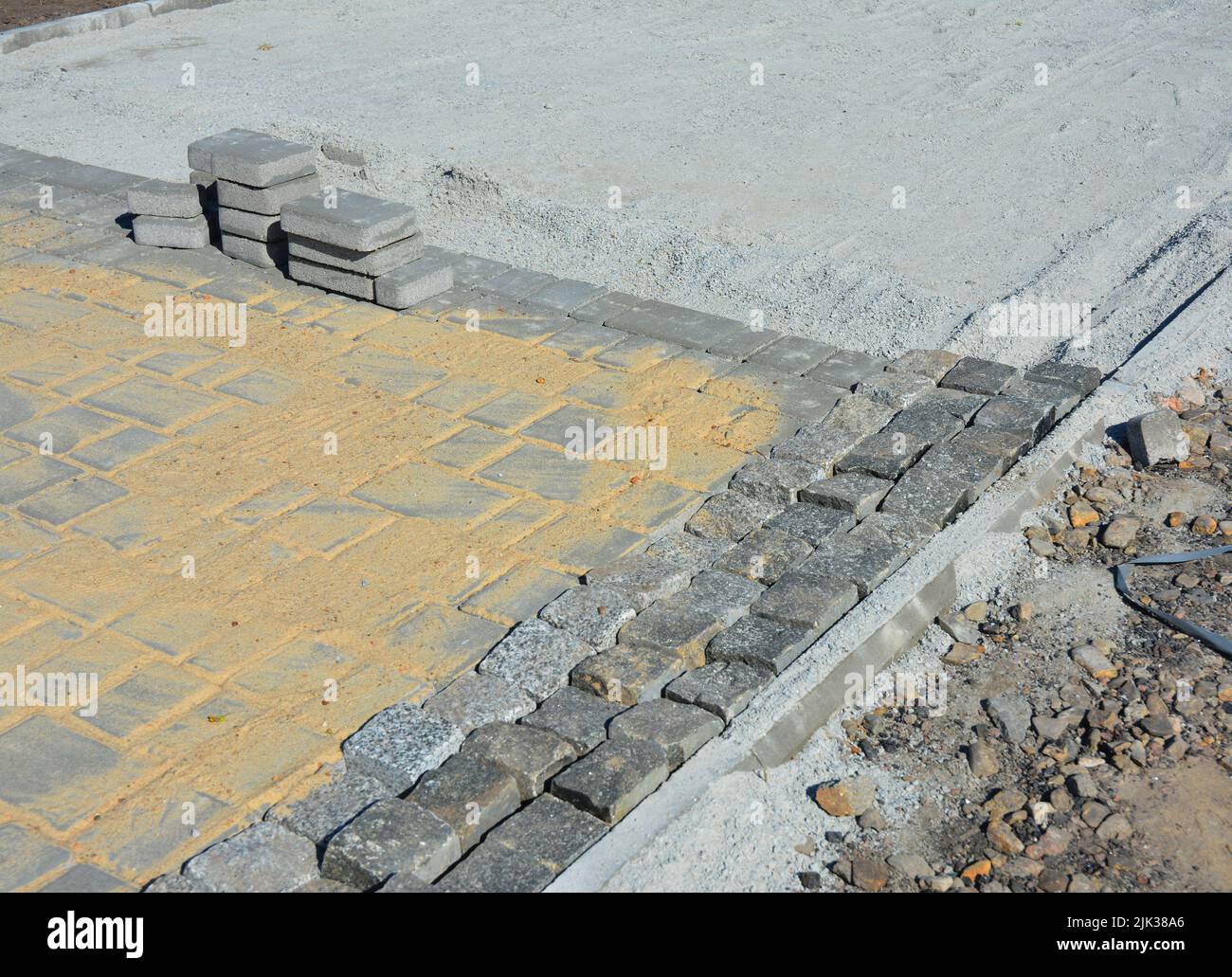 A closeup of a block footpath paving, paver edging and pavers