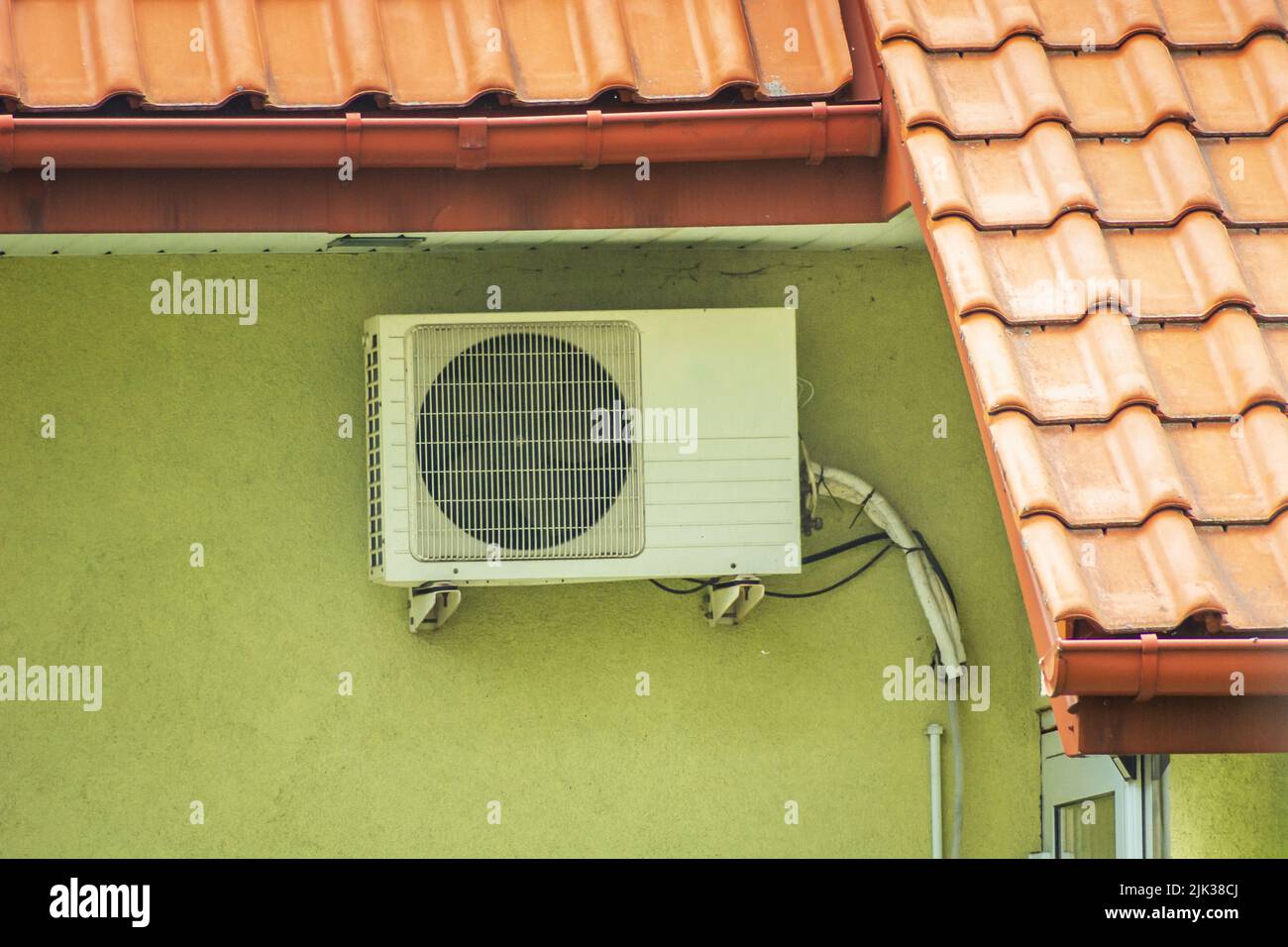Air conditioner hanging on the wall of the building Stock Photo
