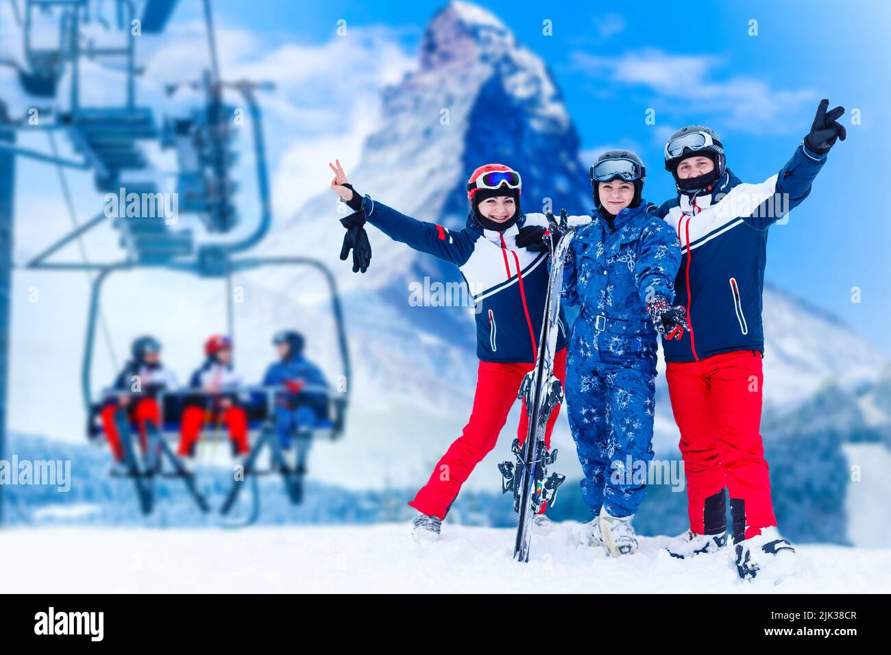 Smiling ski friends skiing alps resort Stock Photo - Alamy