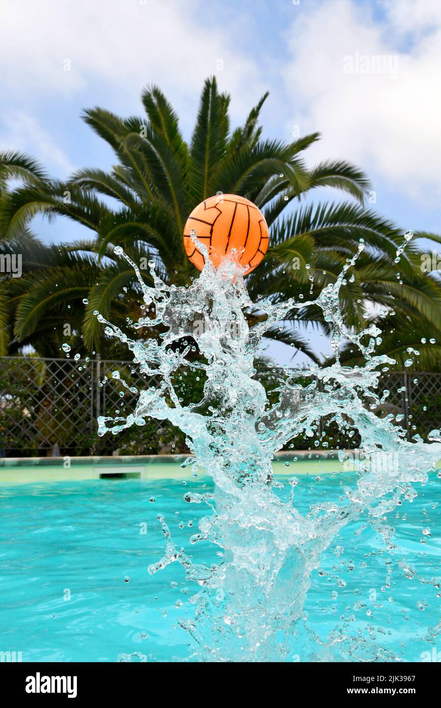 flying up orange ball from swimming pool Stock Photo Alamy