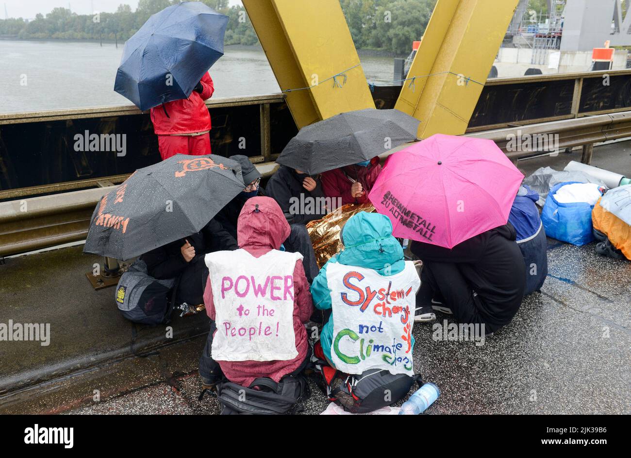GERMANY, Hamburg , activists of deCOALonize europe block the Kattwyk bridge near coal power station Moorburg to protest against coal burning and hard coal imports and weapon trade of Rheimetall Stock Photo